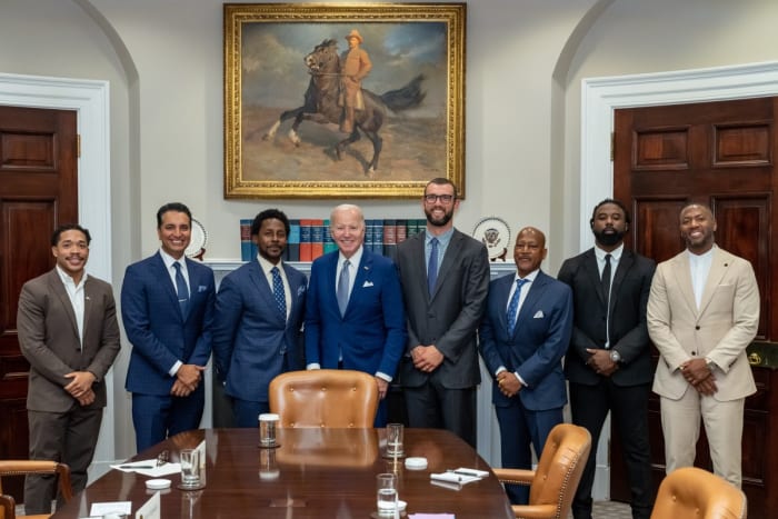 From left: Jordan Meachum, College Football Players Association representative; Kevin Negandhi, ESPN SportsCenter anchor; Desmond Howard, 1991 Heisman Trophy winner and host of ESPN College Gameday; U.S. president Joe Biden; Former Stanford and Colts quarterback Andrew Luck; ESPN college football analyst Rod Gilmore; Keith Marshall, former Georgia running back and Co-Founder/CEO of the Players' Lounge; Former LSU and Steelers safety and current ESPN analyst Ryan Clark